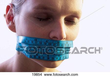 Measuring tape over mouth View Large Photo Image Picture - Measuring tape over mouth. Fotosearch