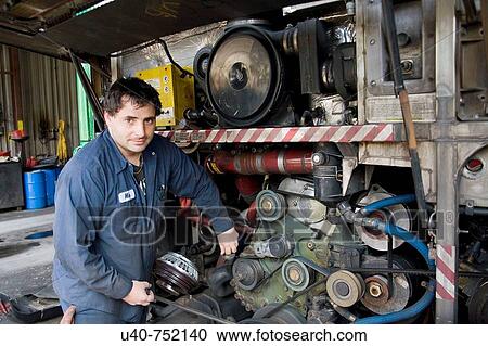 Mechanic working on bus engine View Large Photo Image Stock Image - Mechanic working on bus engine. Fotosearch