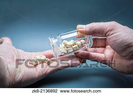 medical pills in a hand poured from a bottle transparent container. View Large Photo Image Stock Image - medical pills in a hand poured from a bottle transparent container.. Fotosearch