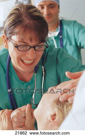 Stock Image - Medical staff visiting patient. Fotosearch