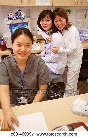 Medical technicians clown at the intake desk at a neighborhood health clinic in a Vietnamese section of Fullerton, California. In foreground is the receptionist View Large Photo Image Stock Photo - Medical technicians clown at the intake desk at a neighborhood health clinic in a Vietnamese section of Fullerton, California. In foreground is the receptionist. Fotosearch