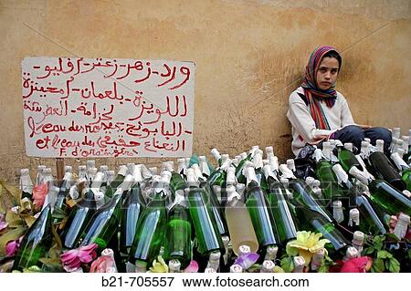 Medina (old part) of Fes, young girl selling roses and oranges water. Morocco. View Large Photo Image Stock Photo - Medina (old part) of Fes, young girl selling roses and oranges water. Morocco.. Fotosearch
