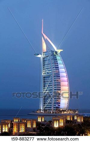 Medinat Jumeirah hotel view to Burj al Arab at dusk, Dubai, United Arabian Emirates View Large Photo Image Stock Photo - Medinat Jumeirah hotel view to Burj al Arab at dusk, Dubai, United Arabian Emirates. Fotosearch