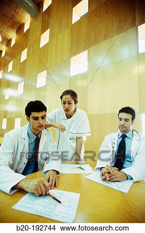 Meeting of doctors at library of hospital View Large Photo Image Picture - Meeting of doctors at library of hospital. Fotosearch