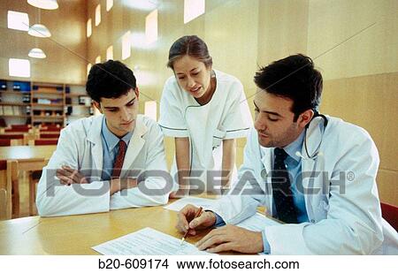 Meeting of doctors at library of hospital View Large Photo Image Picture - Meeting of doctors at library of hospital. Fotosearch