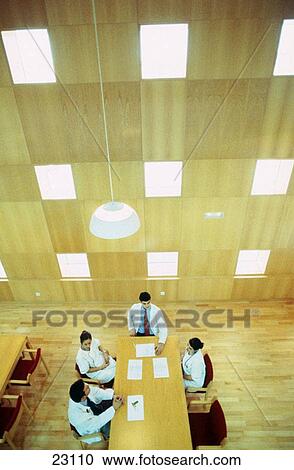 Meeting of doctors at library of hospital View Large Photo Image Stock Image - Meeting of doctors at library of hospital. Fotosearch
