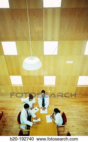 Meeting of doctors at library of hospital View Large Photo Image Stock Image - Meeting of doctors at library of hospital. Fotosearch