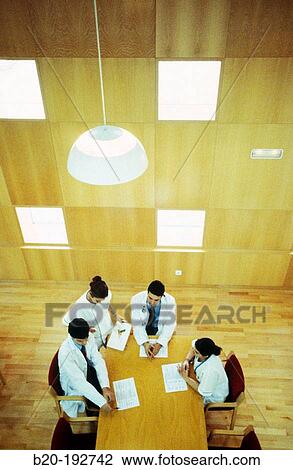 Meeting of doctors at library of hospital View Large Photo Image Stock Image - Meeting of doctors at library of hospital. Fotosearch