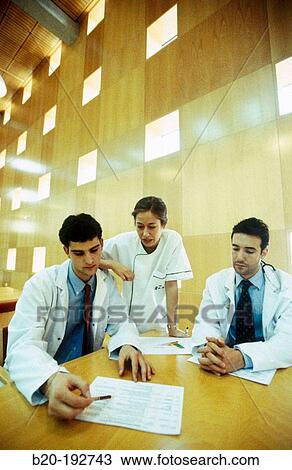 Meeting of doctors at library of hospital View Large Photo Image Stock Image - Meeting of doctors at library of hospital. Fotosearch