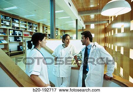 Meeting of doctors at library of hospital View Large Photo Image Stock Photo - Meeting of doctors at library of hospital. Fotosearch