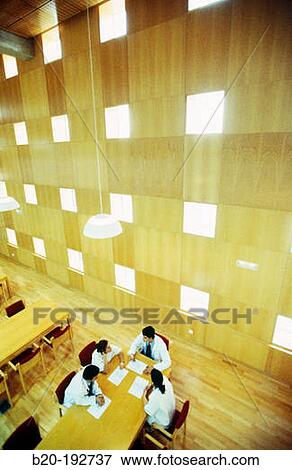 Meeting of doctors at library of hospital View Large Photo Image Stock Photo - Meeting of doctors at library of hospital. Fotosearch