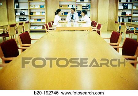 Meeting of doctors at library of hospital View Large Photo Image Stock Photograph - Meeting of doctors at library of hospital. Fotosearch