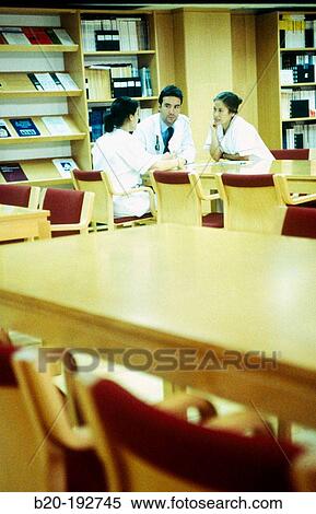 Meeting of doctors at library of hospital View Large Photo Image Stock Photography - Meeting of doctors at library of hospital. Fotosearch