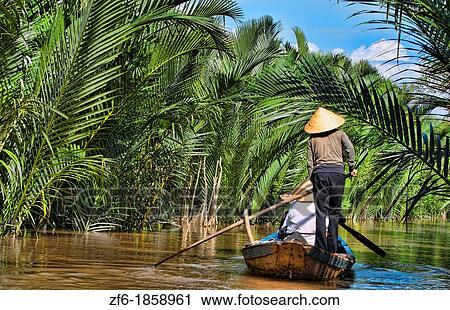 Mekong Delta water river swamps of green muddy water woman in straw hat paddle boating below Saigon Vietnam View Large Photo Image Stock Image - Mekong Delta water river swamps of green muddy water woman in straw hat paddle boating below Saigon Vietnam. Fotosearch