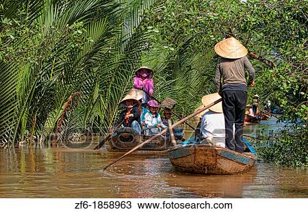 Mekong Delta water river swamps of green muddy water woman in straw hat paddle boating below Saigon Vietnam View Large Photo Image Stock Image - Mekong Delta water river swamps of green muddy water woman in straw hat paddle boating below Saigon Vietnam. Fotosearch