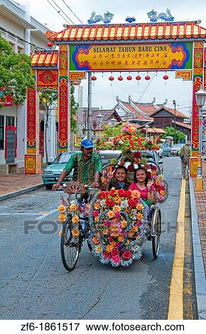 Melaka Malaysia Hertiage City flowers with local man riding trishaw with bike in Asia View Large Photo Image Stock Photo - Melaka Malaysia Hertiage City flowers with local man riding trishaw with bike in Asia. Fotosearch