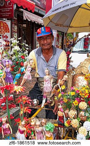 Melaka Malaysia Hertiage City flowers with local man riding trishaw with bike in Asia View Large Photo Image Stock Photo - Melaka Malaysia Hertiage City flowers with local man riding trishaw with bike in Asia. Fotosearch