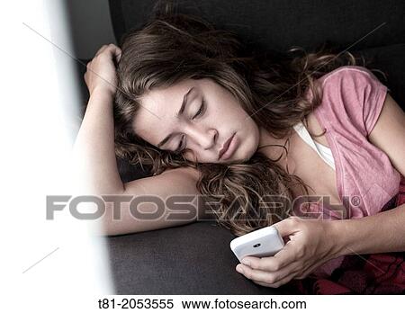Melancholic girl waiting for a call View Large Photo Image Stock Photography - Melancholic girl waiting for a call. Fotosearch
