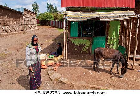 Stock Image - Melka Country Ethiopia Africa Oromo Tribe woman in door of poor home. Fotosearch
