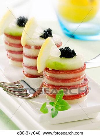 Stock Image - Melon and ham bites.. Fotosearch