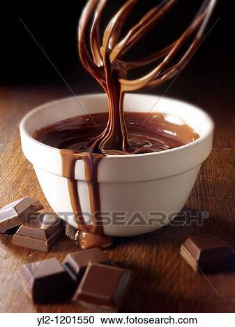 Stock Image - Melted Choclate being stirred in a bowl. Fotosearch