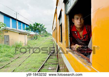 Member of Myanmar's Train Police lookin at moving train View Large Photo Image Stock Image - Member of Myanmar's Train Police lookin at moving train. Fotosearch