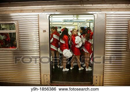 Members of the Varsity Spirit cheerleading team, travel back to their buses via the subway after leading the 86th Annual Macy's Thanksgiving Day parade in New York The team is comprised of elite cheerleaders from around the country View Large Photo Image Stock Photograph - Members of the Varsity Spirit cheerleading team, travel back to their buses via the subway after leading the 86th Annual Macy's Thanksgiving Day parade in New York The team is comprised of elite cheerleaders from around the country. Fotosearch
