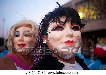 Stock Image - Men from Tlalquetzala, Guerrero, wearing a woman mask perform at the pilgrimage to Our Lady of Guadalupe Basilica in Mexico City, Mexico, December 10, 2013.. Fotosearch