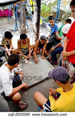 Men gambling in the Streets of the old Town Intramouros in Manila, Philippines. View Large Photo Image Stock Photography - Men gambling in the Streets of the old Town Intramouros in Manila, Philippines.. Fotosearch