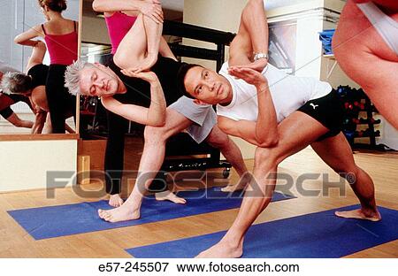 men in contemporary setting (ie. corporate office gym) practicing yoga. View Large Photo Image Stock Photo - men in contemporary setting (ie. corporate office gym) practicing yoga.. Fotosearch