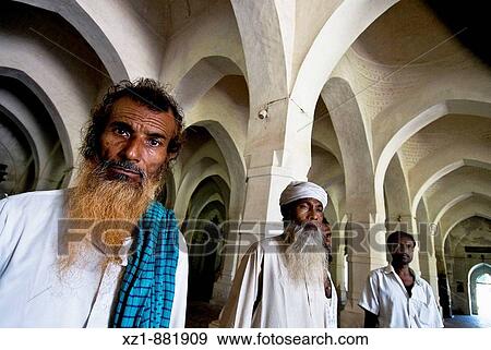 Stock Photo - Men in the Sixty Dome Mosque, Bagerhat, Khulna Division, Bangladesh. Fotosearch