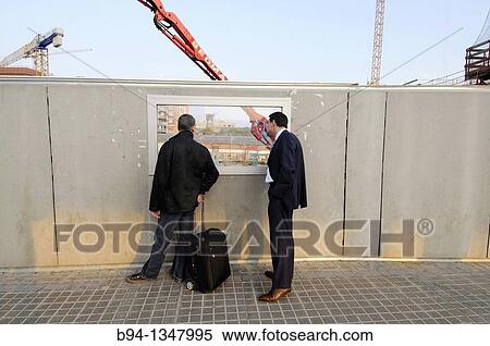 Men looking at construction site, Pla? a de les Glories, Barcelona, Catalonia, Spain View Large Photo Image Stock Photography - Men looking at construction site, Pla? a de les Glories, Barcelona, Catalonia, Spain. Fotosearch