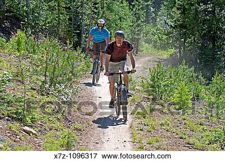 Men mountain biking The Growler Trail at Brundage Mountain Ski Resort near the town of McCall in the Salmon River Mountains of central Idaho USA View Large Photo Image Stock Photo - Men mountain biking The Growler Trail at Brundage Mountain Ski Resort near the town of McCall in the Salmon River Mountains of central Idaho USA. Fotosearch