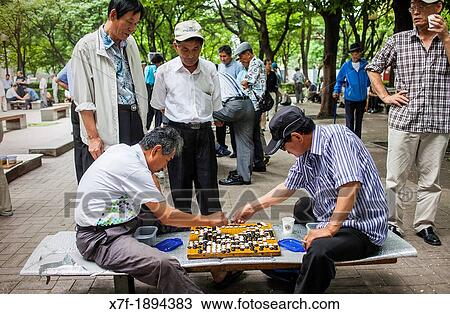 Men playing Baduk at Jongmyo park, Seoul, South Korea View Large Photo Image Stock Image - Men playing Baduk at Jongmyo park, Seoul, South Korea. Fotosearch