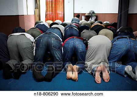 Stock Image - Men praying during Ramadan, Girona. Catalonia, Spain. Fotosearch