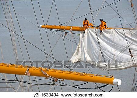 Men repairing a sail of the three-masted sailboat on Guayas river, used as a training ship for Ecuadorian Navy cadets, Guayaquil, Ecuador View Large Photo Image Picture - Men repairing a sail of the three-masted sailboat on Guayas river, used as a training ship for Ecuadorian Navy cadets, Guayaquil, Ecuador. Fotosearch
