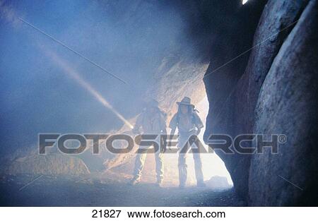 Men walking into dark cave with flashlights View Large Photo Image Stock Photo - Men walking into dark cave with flashlights. Fotosearch