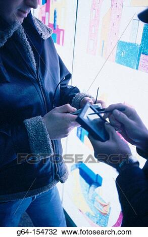 Stock Image - Men with cell phone and PDA. Fotosearch