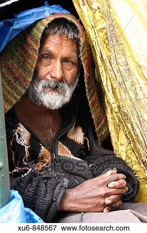 Stock Photo - Mentally disabled man sitting in his makeshift home on the street McLeod Ganj, Himachal Pradesh, India. Fotosearch
