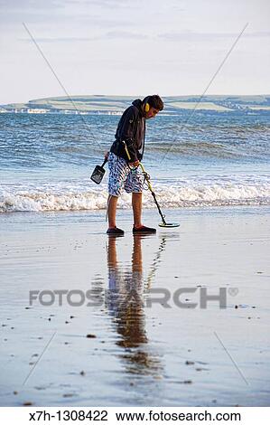 Metal detecting on Bournemouth beach, Bournemouth, England View Large Photo Image Stock Image - Metal detecting on Bournemouth beach, Bournemouth, England. Fotosearch