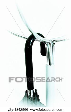 Metal hanger with black umbrella View Large Photo Image Stock Photograph - Metal hanger with black umbrella. Fotosearch