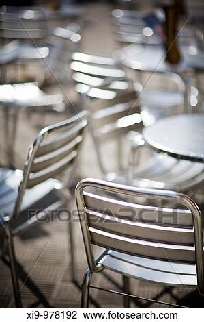 Stock Image - Metallic seats and tables of an outdoor restaurant, Seville, Spain. Fotosearch