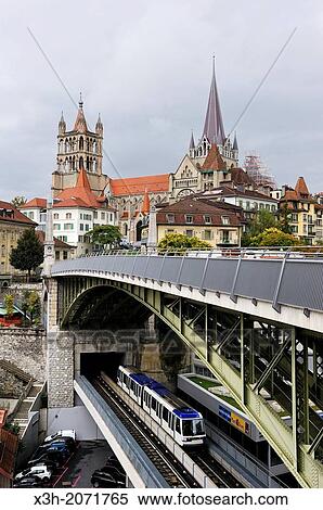 Stock Photography - Metro railway on St-Martin bridge under the Bessieres bridge with the Cathedral of Notre Dame in background, Lausanne, Canton of Vaud, Switzerland, Europe.. Fotosearch