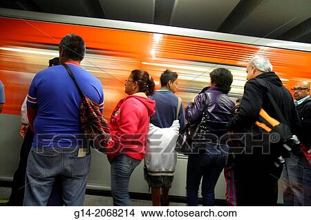 Picture - Mexico, Mexico City, DF, D. F., Distrito Federal, Metro subway, STC, mass transit, public transportation, Hildago Station, Line 2, platform, Hispanic, man, woman, standing, train, moving, motion, arriving, commuter,.. Fotosearch