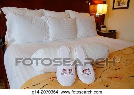 Picture - Mexico, Mexico City, DF, D. F., Distrito Federal, Paseo de la Reforma, Marriott Reforma Hotel, American hotel chain, hospitality, lodging, guest room, bed, bedding, nightstand, pillow, lamp, comfort, slippers, houseshoe, logo, made,.. Fotosearch