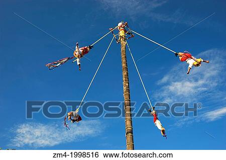 Stock Photograph - MEXICO, NEAR CANCUN, XCARET ECO THEME PARK, PAPANTLA FLYING MEN PERFORMANCE (ANCIENT MAYAN CEREMONY TO ASK FOR A GOOD HARVEST AND FERTILITY).. Fotosearch