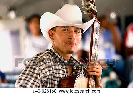 Stock Image - Mexico, Puerto Vallarta. Young man with guitar.. Fotosearch