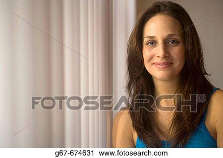 Mid 20s caucasian woman smiles for portrait photograph in a home in Los Angeles, CA, USA View Large Photo Image Stock Image - Mid 20s caucasian woman smiles for portrait photograph in a home in Los Angeles, CA, USA. Fotosearch