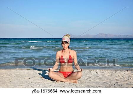 Mid adult woman doing yoga on beach, Mallorca, Spain View Large Photo Image Picture - Mid adult woman doing yoga on beach, Mallorca, Spain. Fotosearch