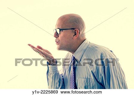 Middle-age bald man blowing a kiss. View Large Photo Image Stock Photo - Middle-age bald man blowing a kiss.. Fotosearch